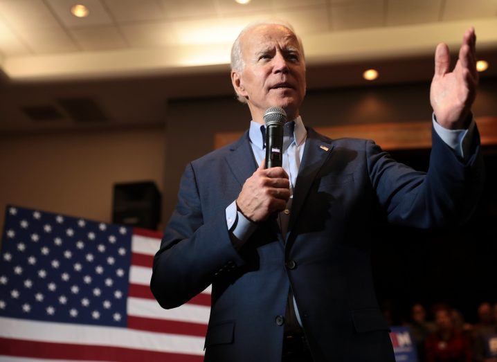 Photo of Joe Biden giving a speech with the US flag visible behind him.