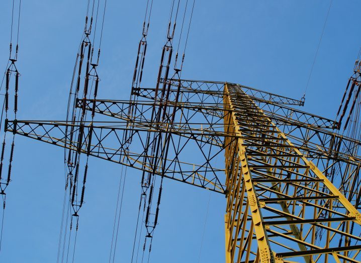 Power lines with a blue sky in the backdrop.