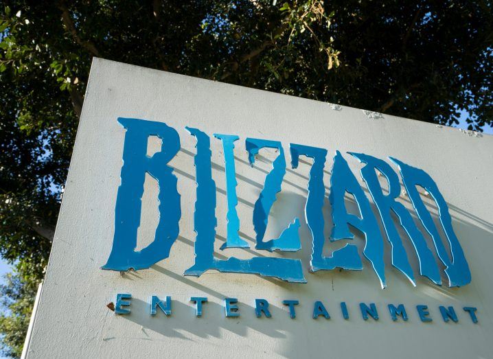 Blizzard logo on a white block under trees.