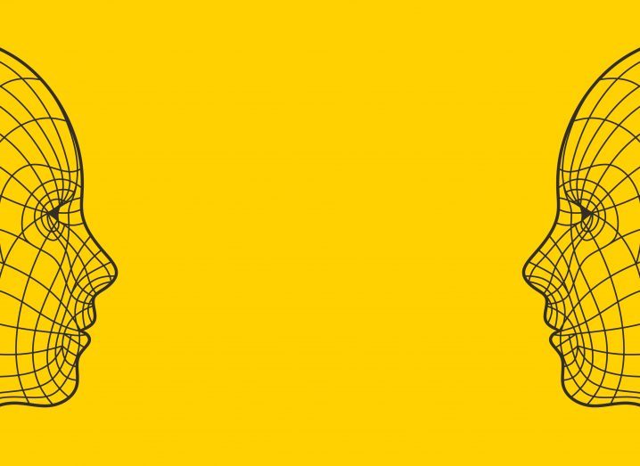 An illustration of two faces representing AI looking at each other in a bright yellow background.