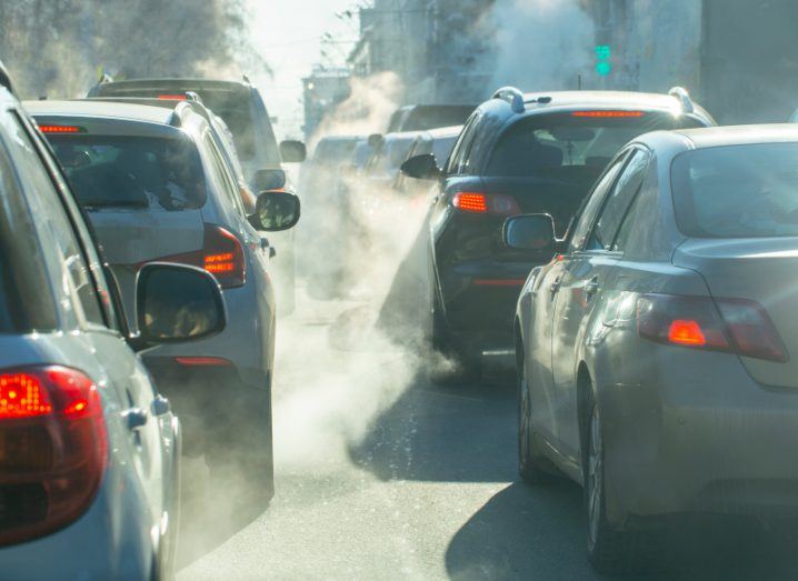 A road full of cars with smoke surrounding them. Used to represent traffic emissions.