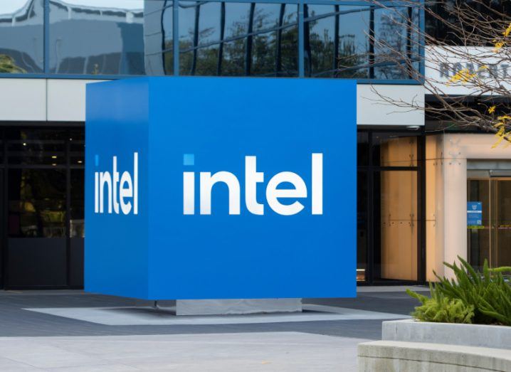 The Intel logo on a blue cube outside of a building.