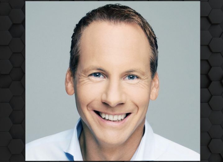 A man wearing a white shirt smiles at the camera. He is Daniel Keller, chief technology officer at Onfido.