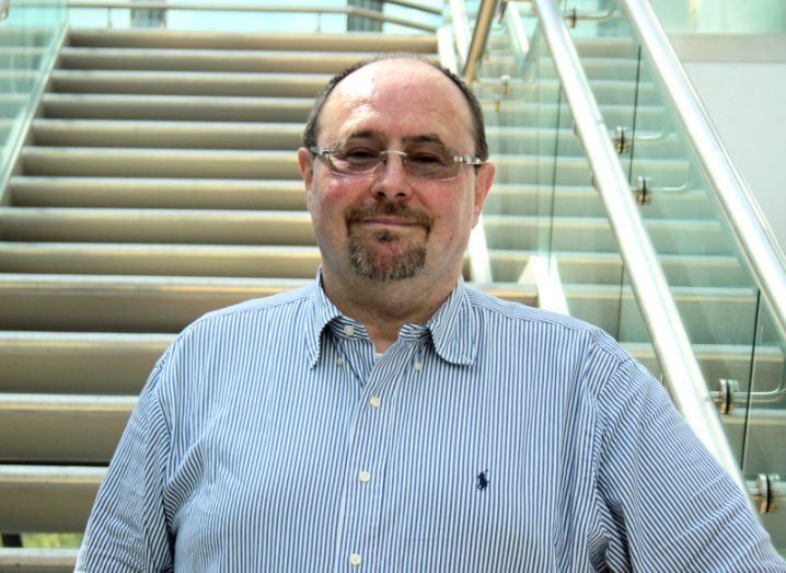 Prof Sakis Mantalaris standing in front of a stairwell.