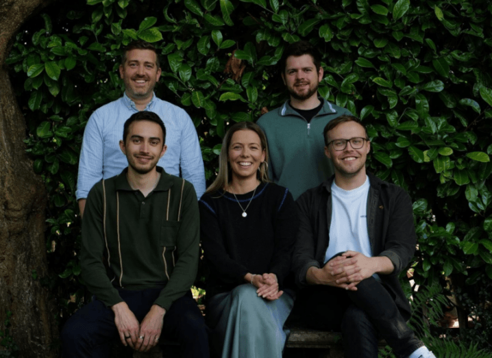 Four men and a woman in two rows, in front of a green hedge. They are part of the Ctrl Alt team.