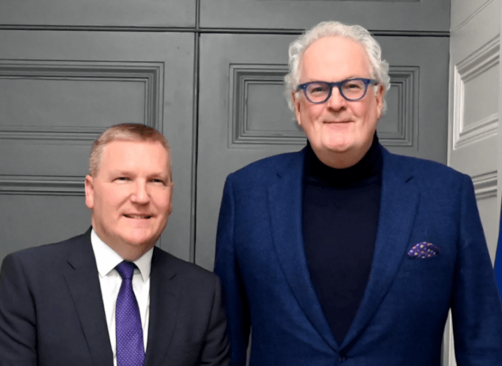 Two men standing next to each other in front of a grey door. They are part of the Irish Government and Navro.